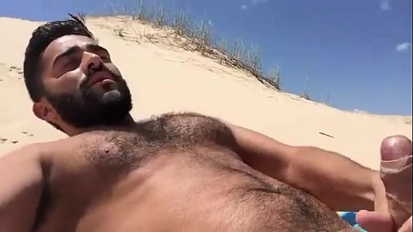 Hairy chest cumming in the sand
